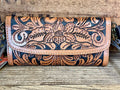 Cowhide tooled leather wallet front flap, floral scroll tooling, and snap closure
