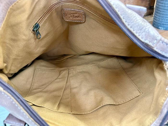 Taupe fabric-lined purse interior with stitched panels and zipper opening