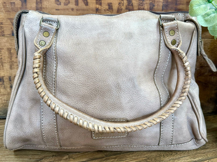 Light gray leather purse front with braided handle strap and metal snap closures