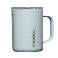 A light blue insulated mug with a clear lid and a vertical CORKICLE logo printed on the front, set against a plain white background.
