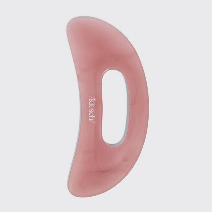 Kitsch Body Gua Sha in terracotta pink, curved massage tool on neutral background