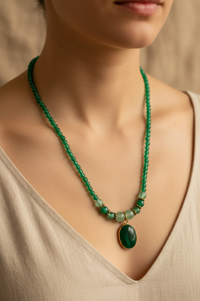 Model wearing green necklace